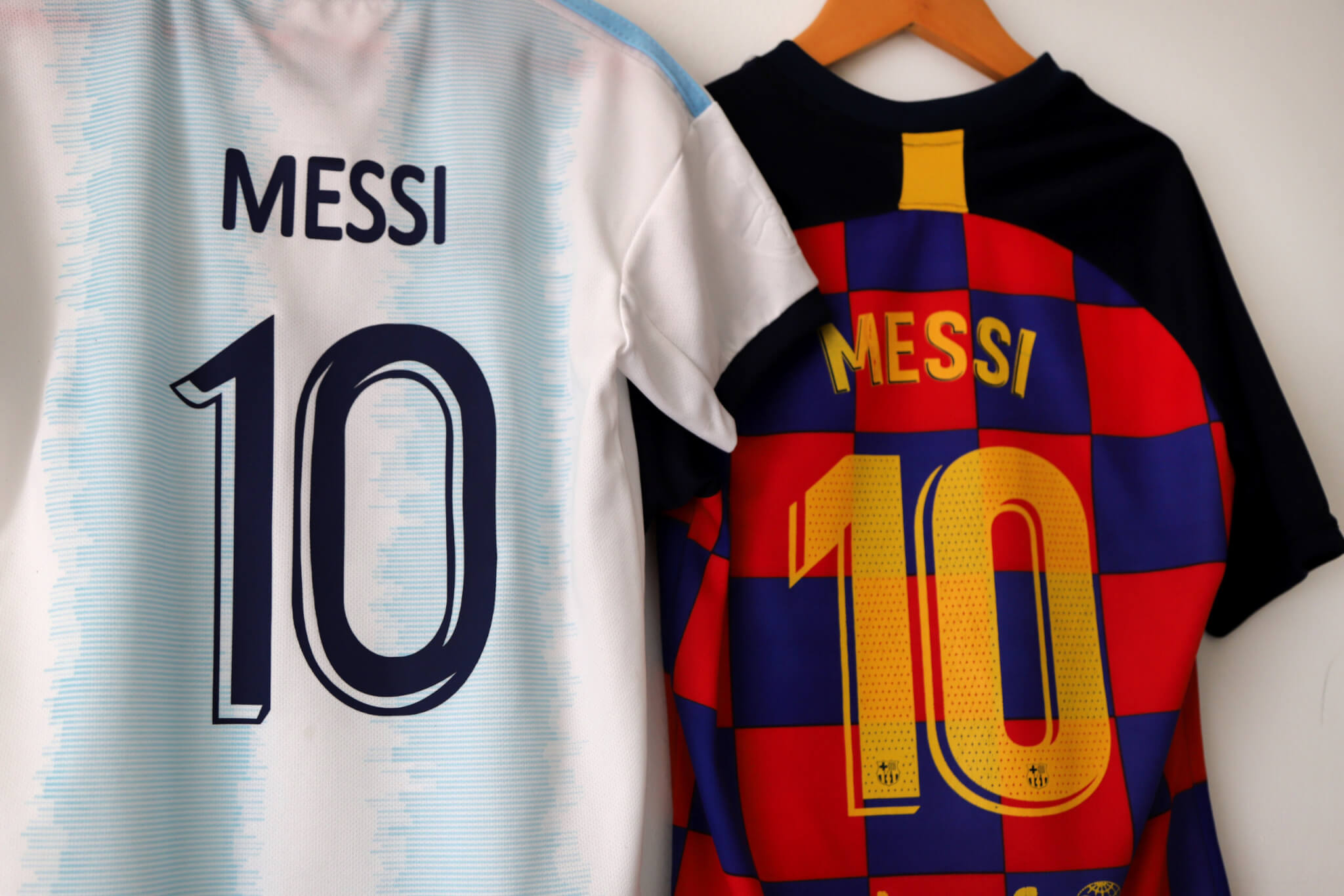 Argentina football shirt of Lionel Messi, along with Messi's Barcelona shirt.