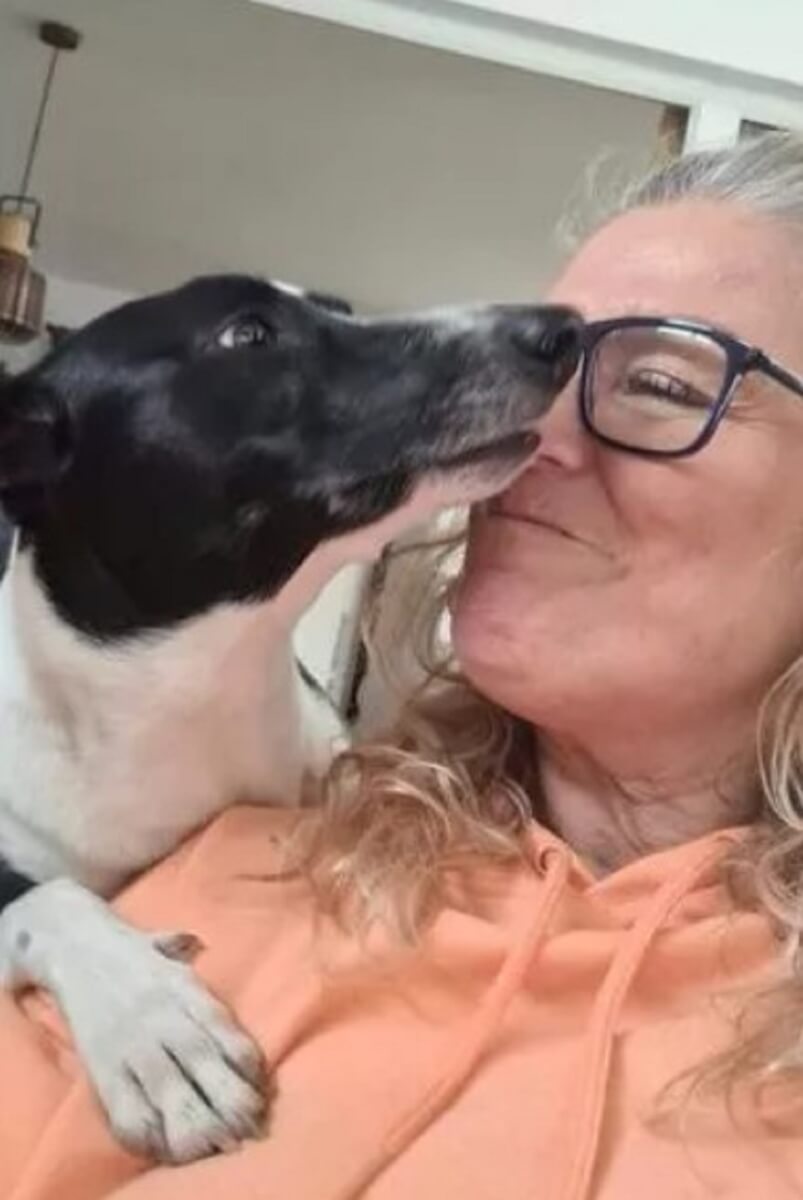 woman kissing her dog