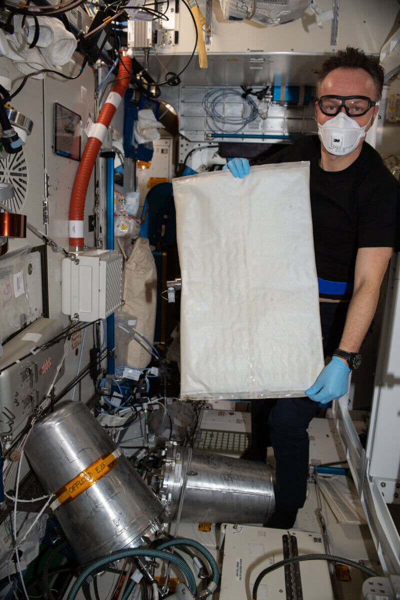 ESA (European Space Agency) astronaut Matthias Maurer changes out the bladder in the space station’s Brine Processor Assembly. 