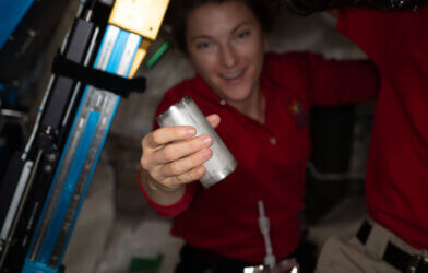 NASA astronaut Kayla Barron replaces a filter in the space station’s Brine Processor Assembly.