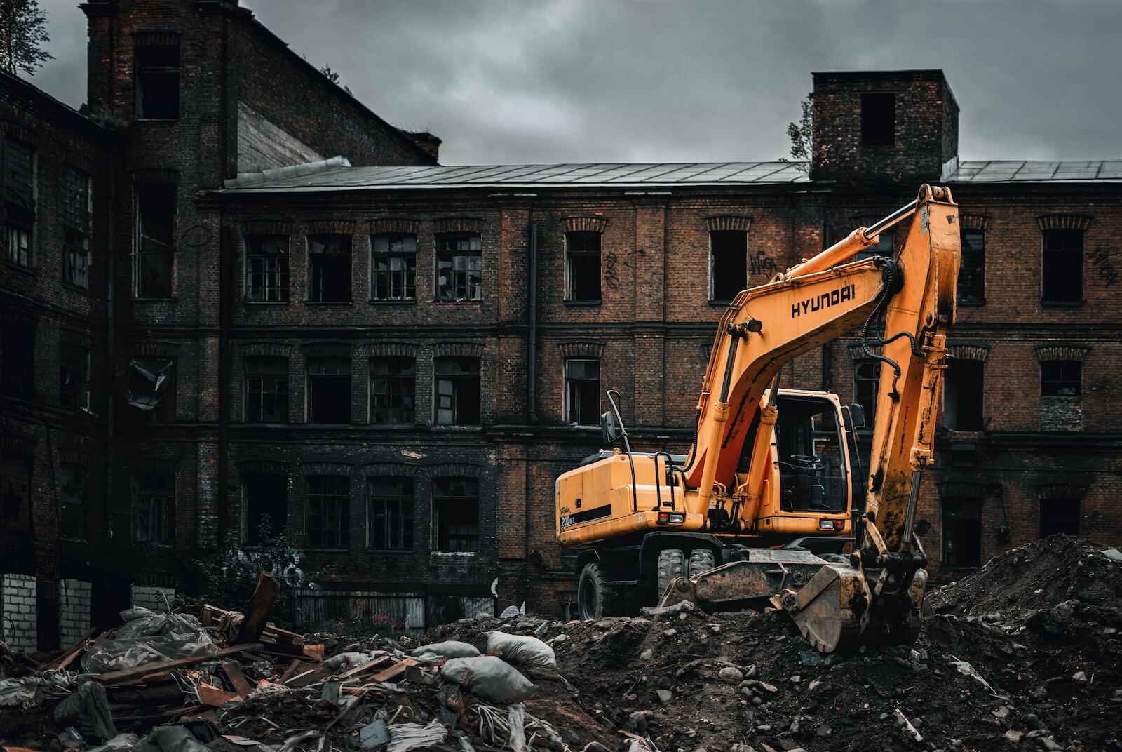 excavator demolishing old buildings