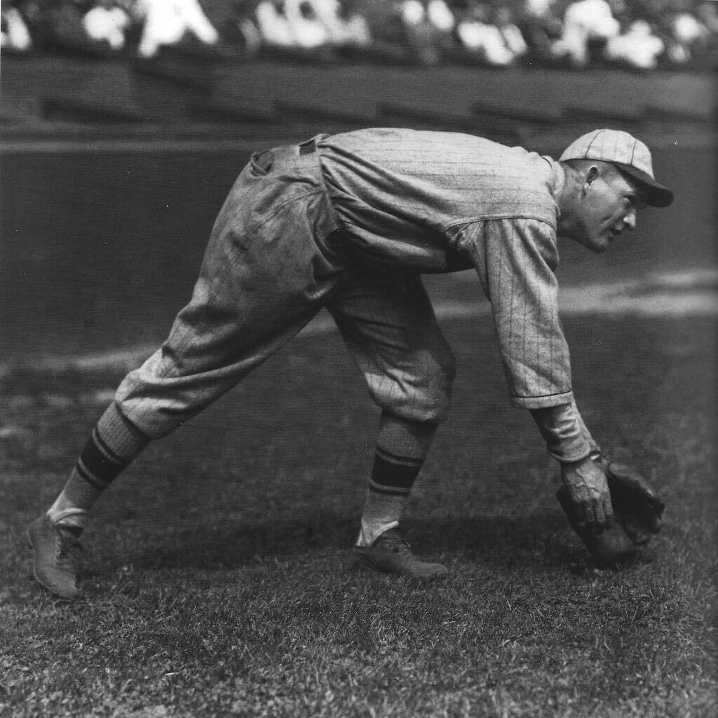 grayscale image of Rogers Hornsby following through with a throw 