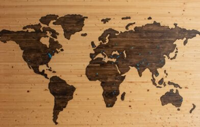 brown wooden map of the continents