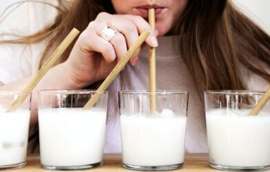 A woman taste-testing milks