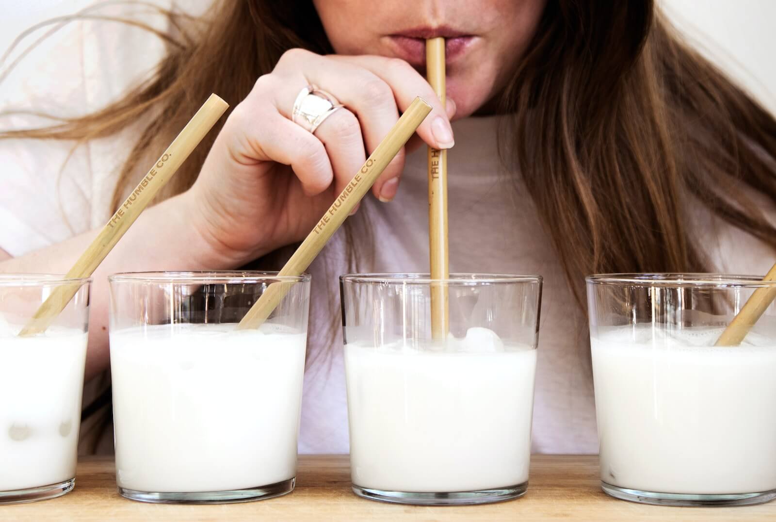 A woman taste-testing milks