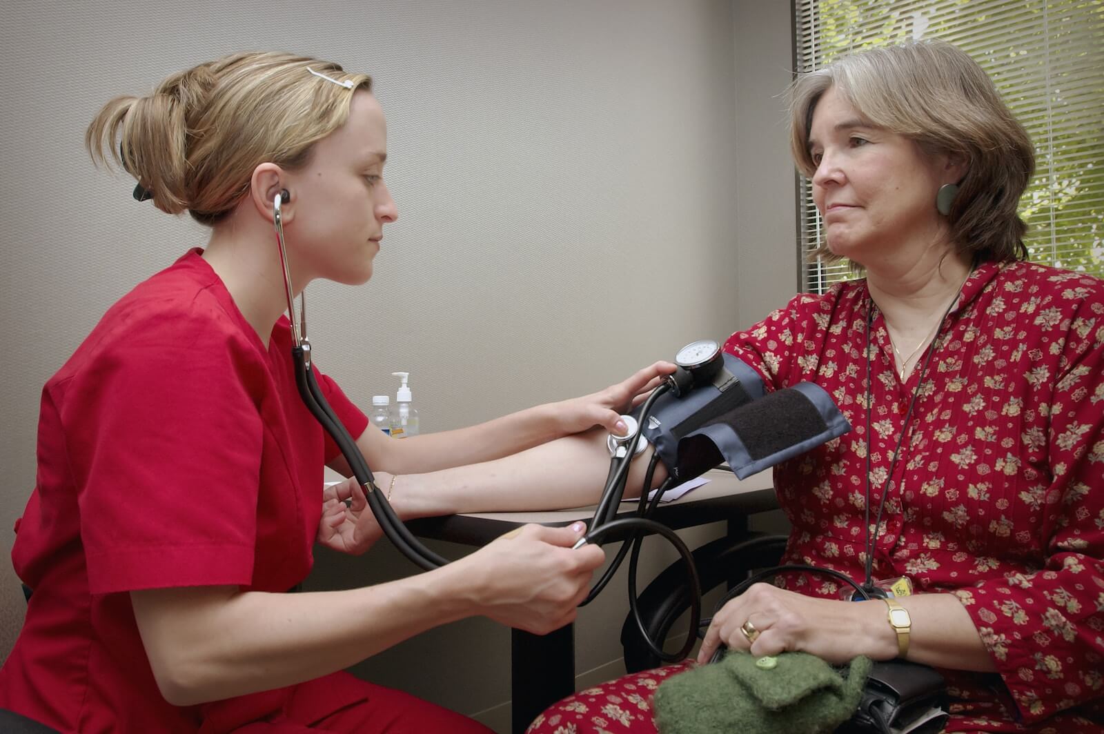 Female patient has blood pressure measured