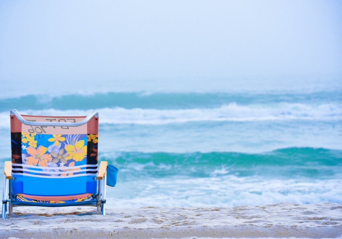 blue and white beach chair on beach during daytime