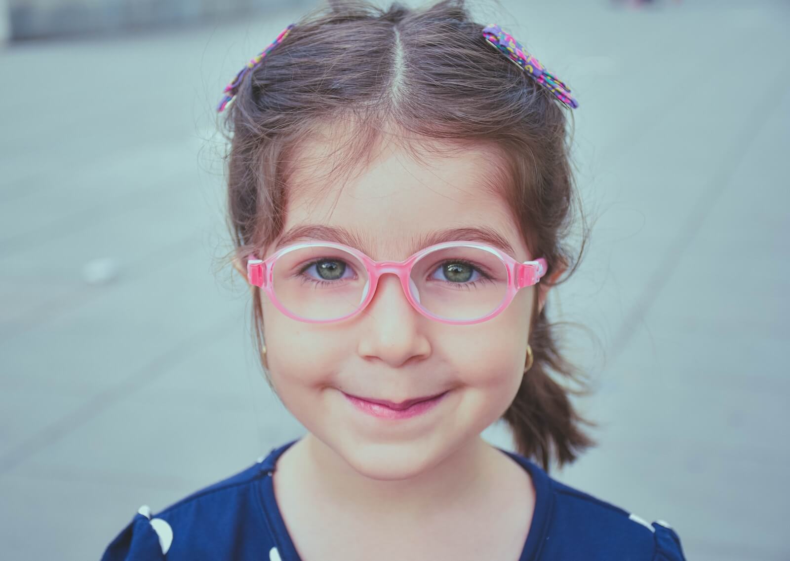 girl in pink framed eyeglasses