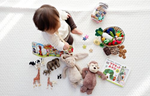Toddler surrounded by toys