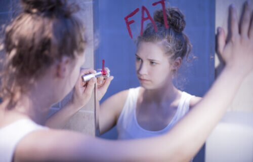 Teen girl in the bathroom with an eating disorder