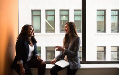 Two women having conversation at the office