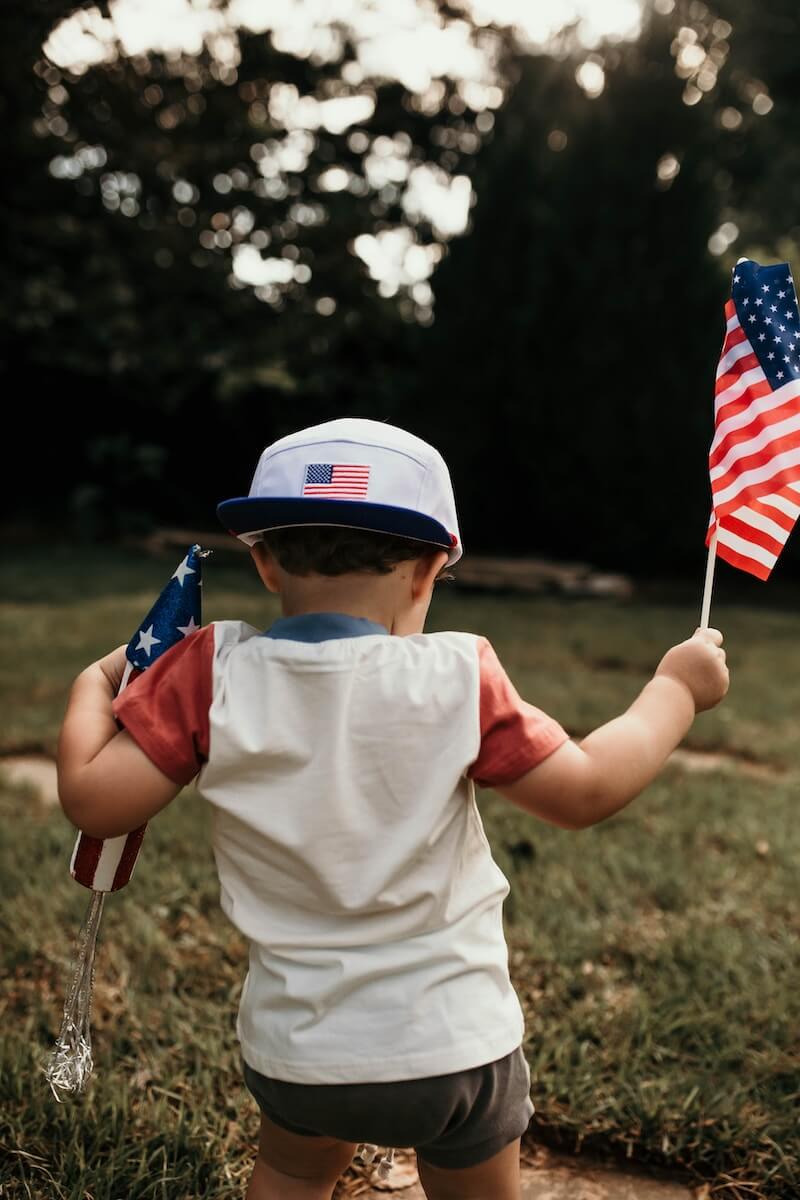 A little boy holding an American flag