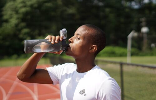 A man drinking a bottle of water