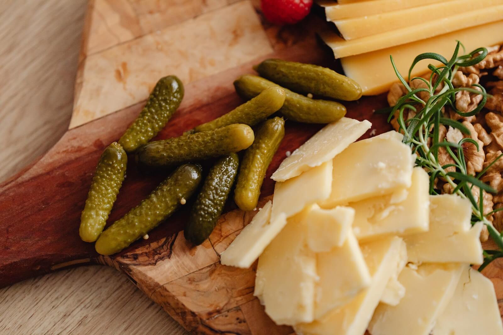 Pickles and cheese on a cutting board