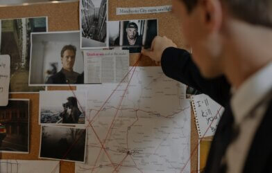 Detective putting clues together on a bulletin board