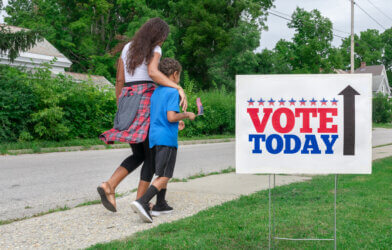 Mother walking to vote with child