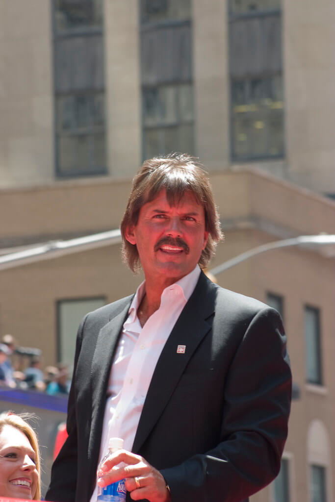 Oakland A's legend Dennis Eckersley smiling in a parade
