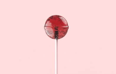 red lollipop on white stick