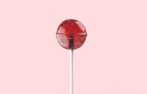 red lollipop on white stick
