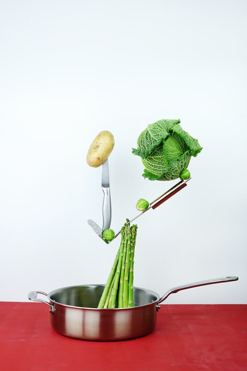 Abstract image of asparagus and other vegetables in a pan