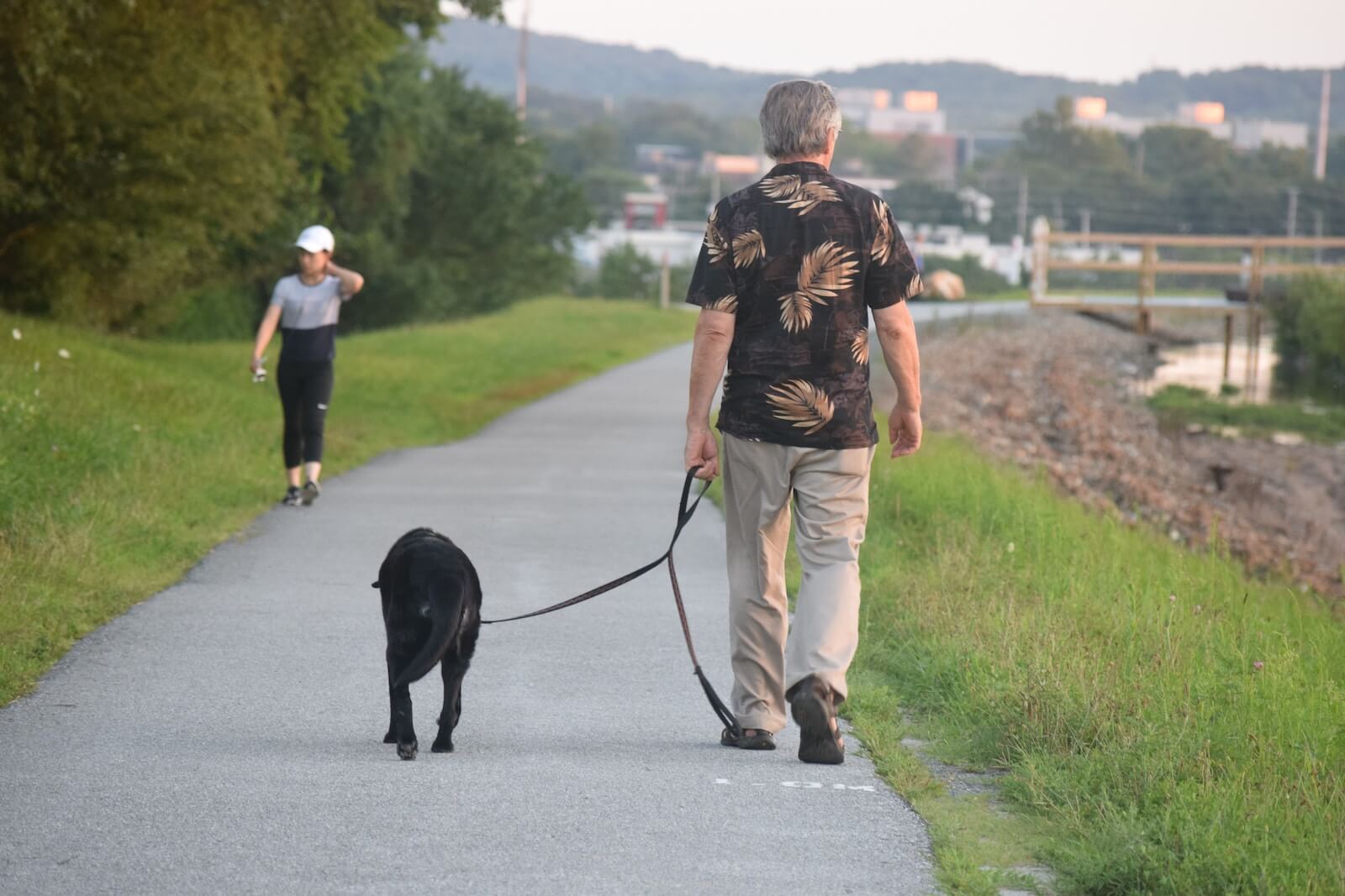 A man walking his dog at Newark Reservoir in Delaware