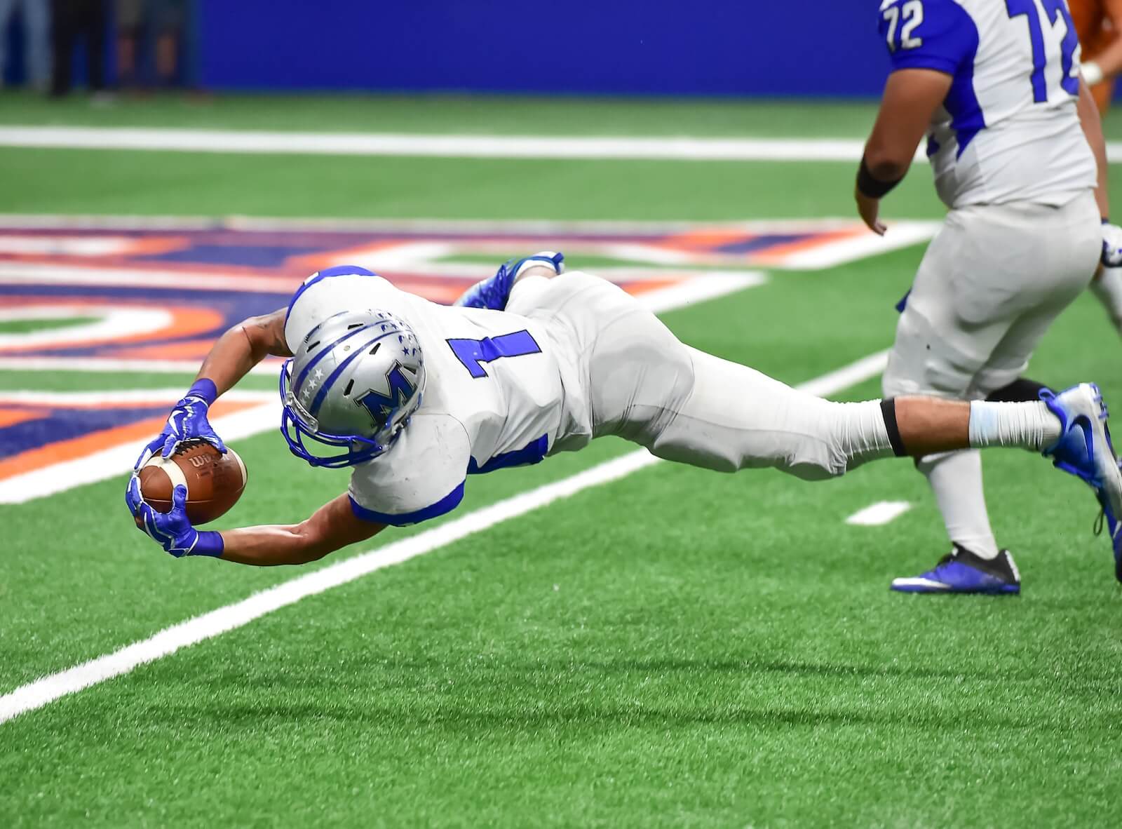 Football Player diving into the endzone