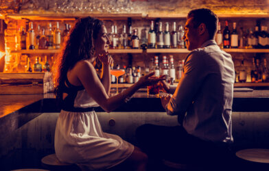 couple sitting at the bar talking
