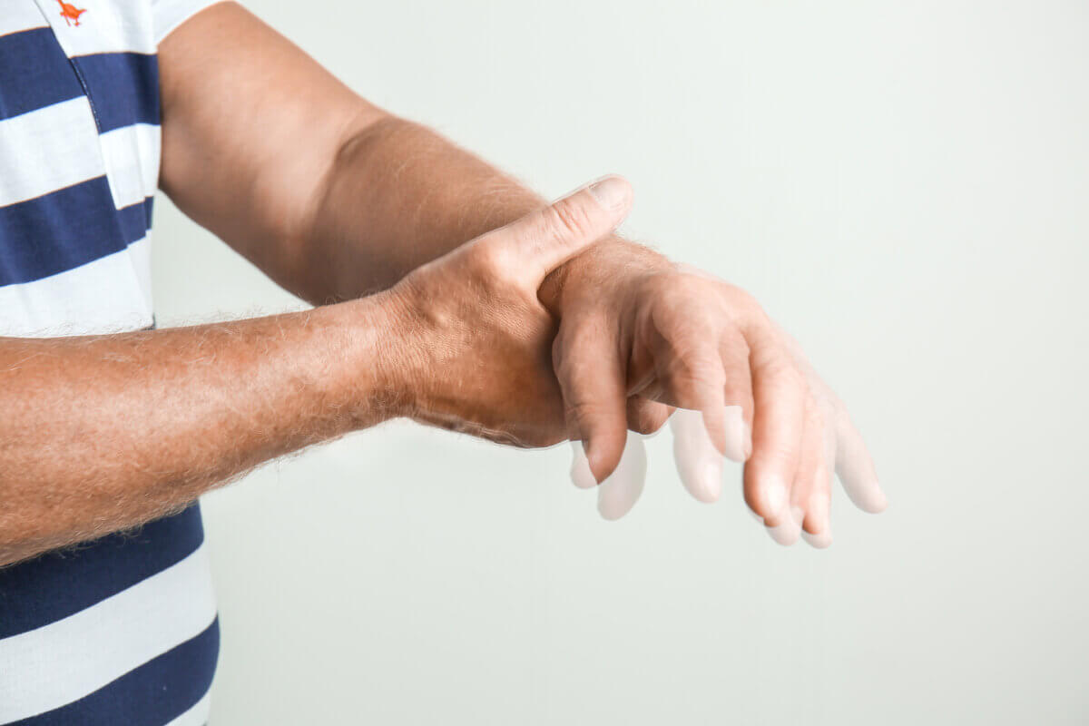 Senior man suffering from hand tremors due to Parkinson's disease