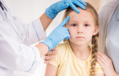 Doctor examining child head injury