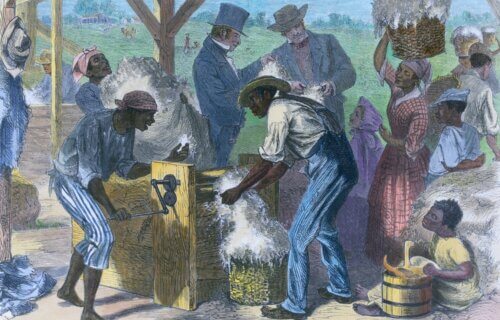 African American slaves using a cotton gin