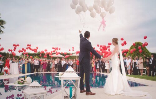 man and woman wedding holding balloons