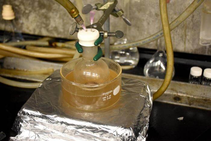 A flask filled with waxes generated from waste polyethylene and polypropylene is heated