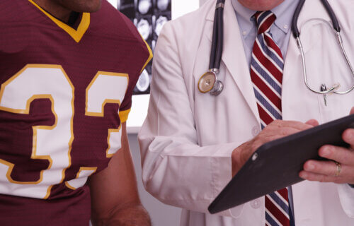 Football player talking to a doctor