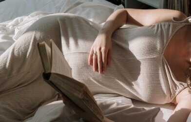 A pregnant woman reading a book