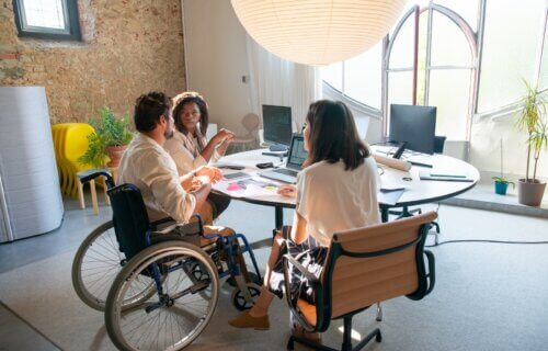Person in wheelchair at office Meeting