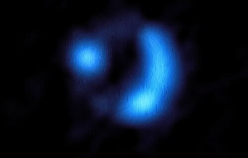 This image shows the orientation of the magnetic field in the distant 9io9 galaxy, it looks like a blue dot and a blue crescent moon