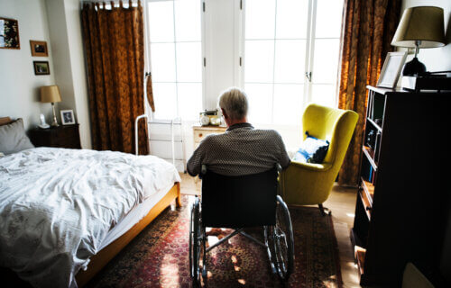 Senior man sitting on the wheelchair alone in nursing home