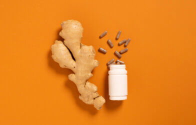 Fresh ginger root jar with vitamin pills