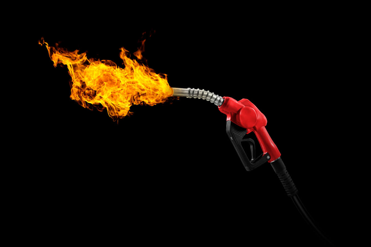 gasoline injector with fire on black background