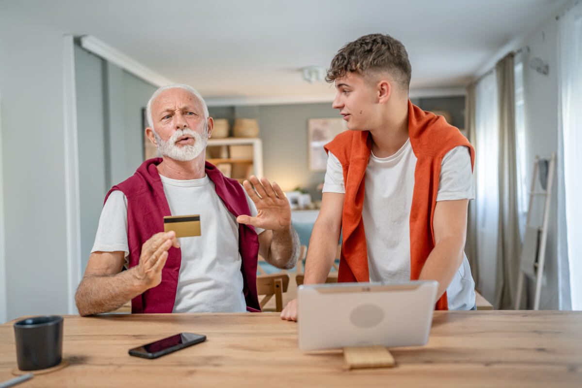 teenager and senior grandfather argue about money