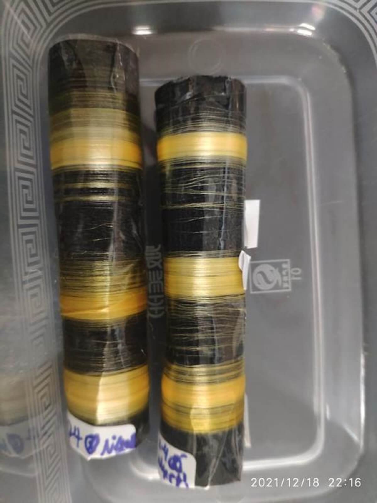 yellow and black Silk fibers produced by transgenic silkworms.