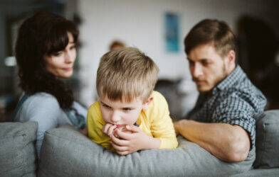 Parents disciplining talking to child after bad behavior