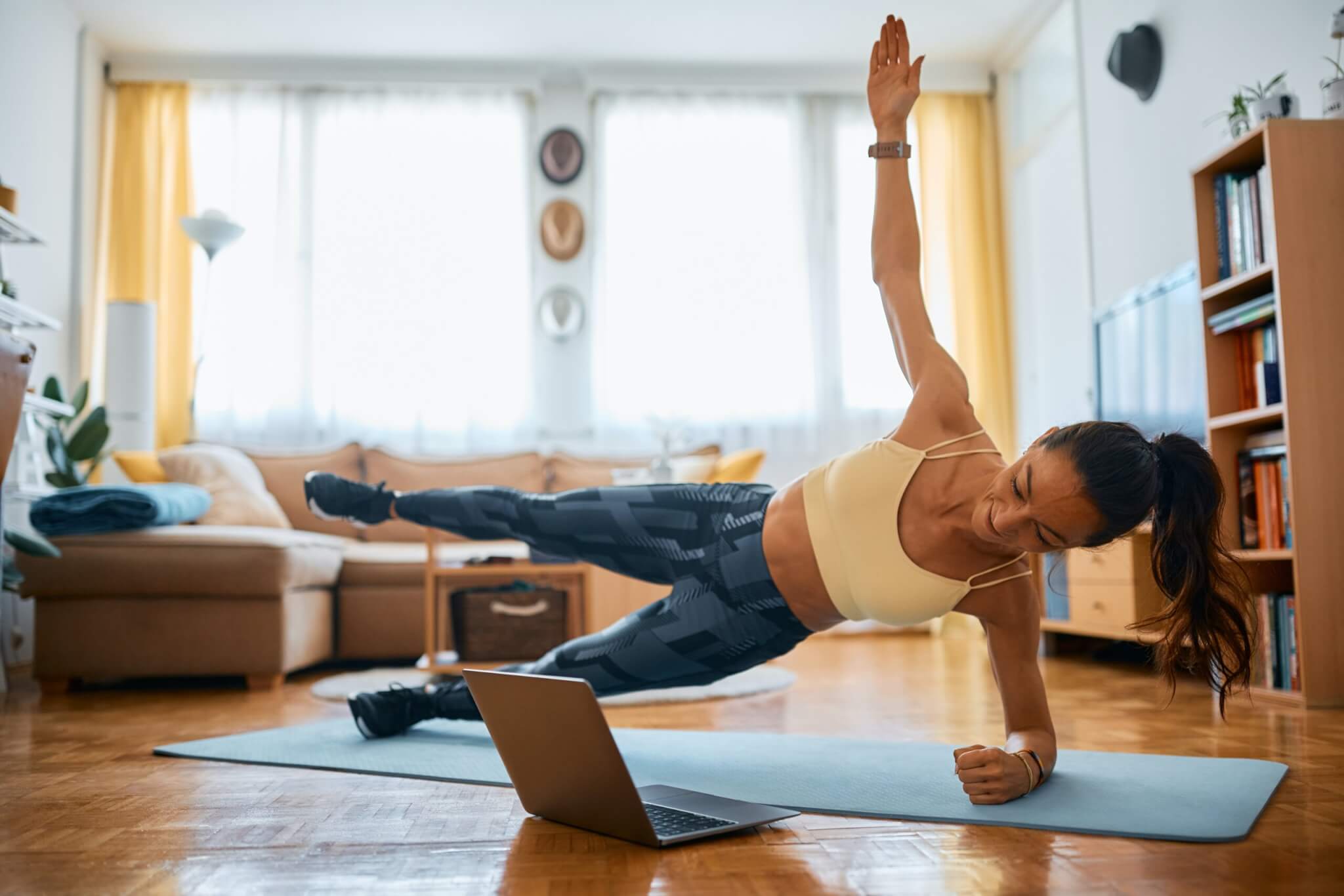 Woman performing a side plank at home