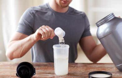 Man using health supplement powder in a shake