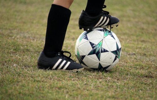 A child playing soccer in Adidas cleats