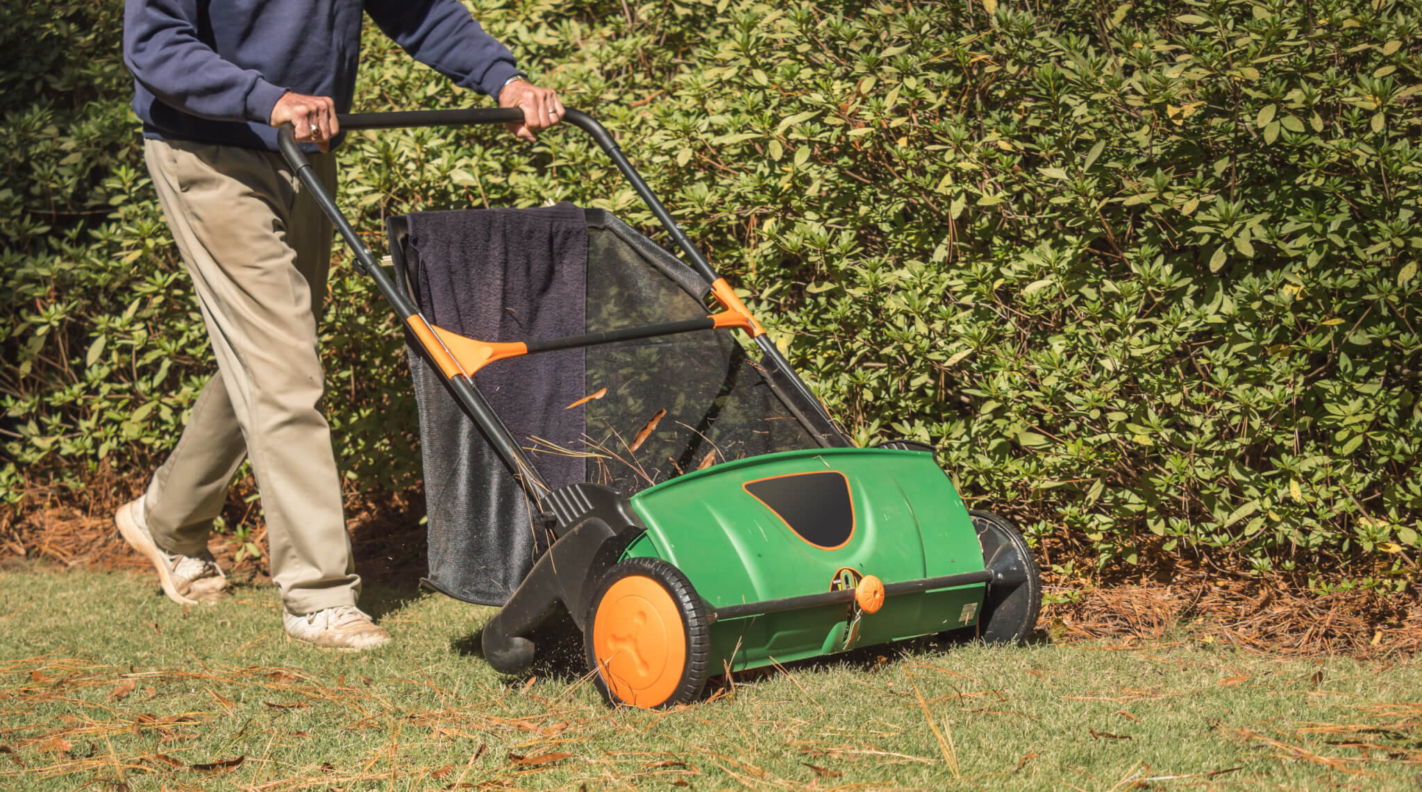 Man using a lawn sweeper