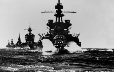 Battleship USS Pennsylvania is followed by three cruisers. They enter the Lingayen Gulf to support the U.S. Invasion of Luzon Island. Jan. 1945. Philippines, Pacific Ocean, World War II. (Credit: shutterstock/Everett Collection)
