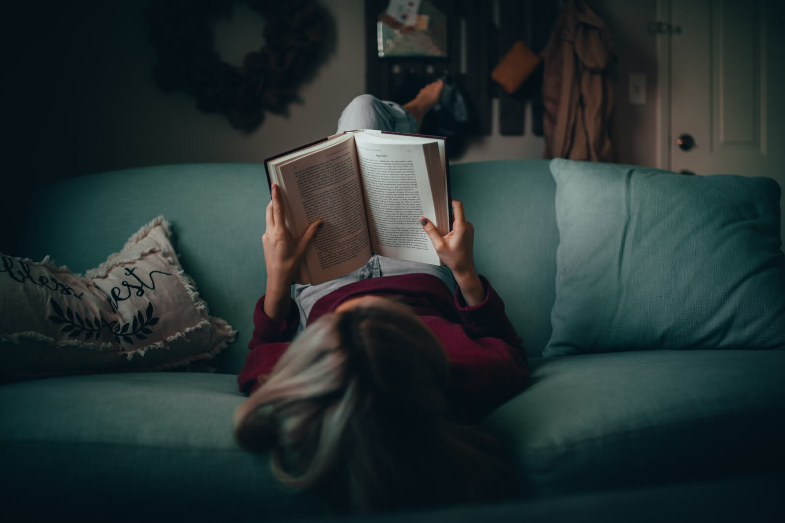 woman in red shirt reading book photo by Matias North on Unsplash