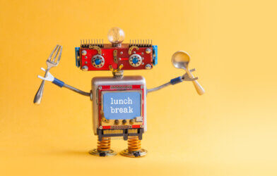 Funny robot with fork and spoon in arms