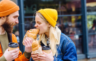 man feeding blond hungry woman in cold weather